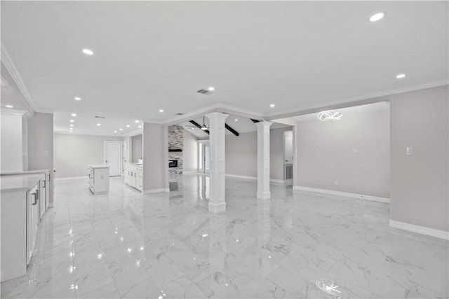 6417 Coral Gables Dr, Corpus Christi, TX 78413 - spare room featuring recessed lighting, ornamental molding, decorative columns, light marble finish flooring, and a stone fireplace