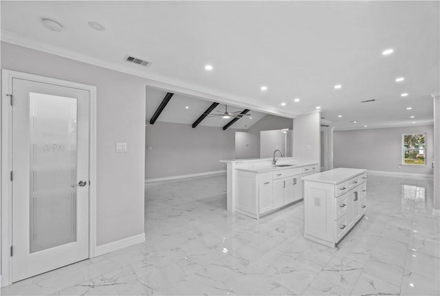 6417 Coral Gables Dr, Corpus Christi, TX 78413 - kitchen featuring open floor plan, a kitchen island, white cabinets, light marble finish floors, and recessed lighting