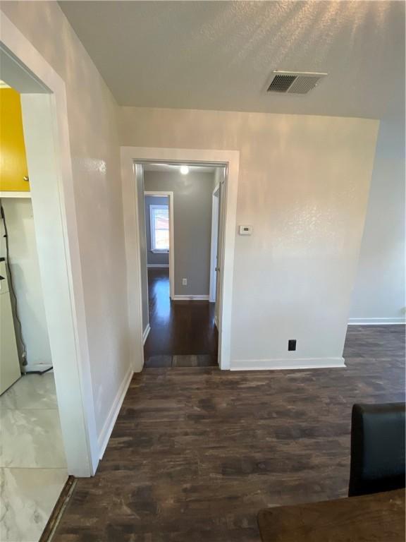 hallway featuring dark hardwood / wood-style flooring