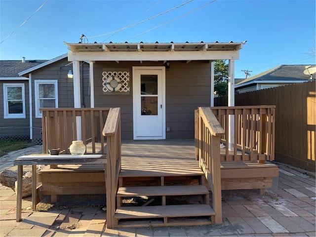 rear view of property featuring a wooden deck