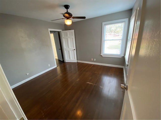 spare room with ceiling fan and dark wood-type flooring