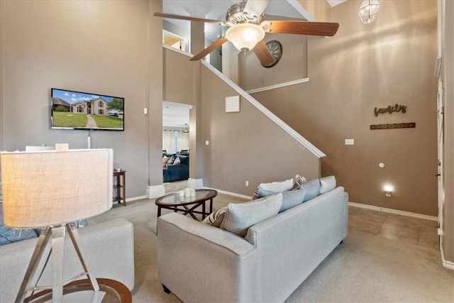 3901 Gibraltar Dr, Corpus Christi, TX 78414 - living room with a high ceiling, ceiling fan, baseboards, stairs, and carpet floors