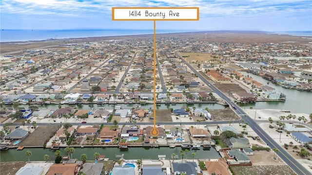 drone / aerial view featuring a water view and a residential view