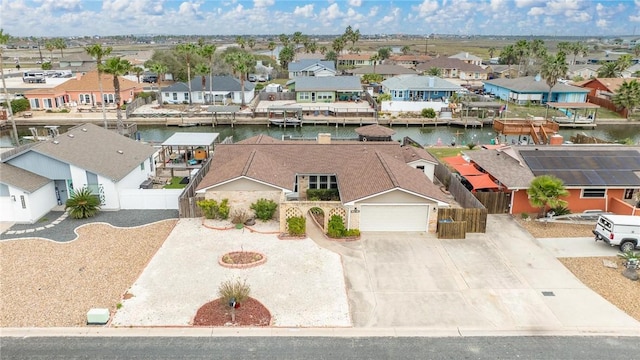 birds eye view of property with a water view and a residential view