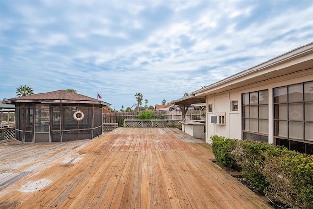 wooden deck featuring a gazebo and fence