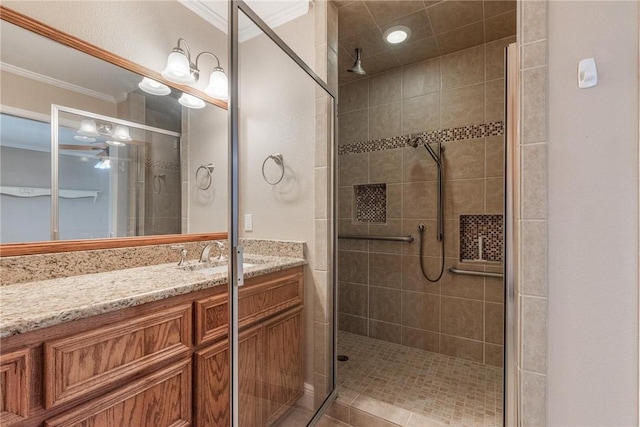 bathroom with a stall shower, crown molding, and vanity