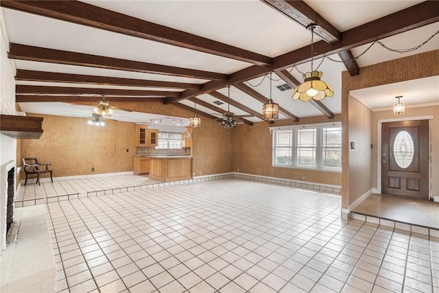 foyer featuring wooden walls, visible vents, lofted ceiling with beams, ceiling fan, and light tile patterned flooring