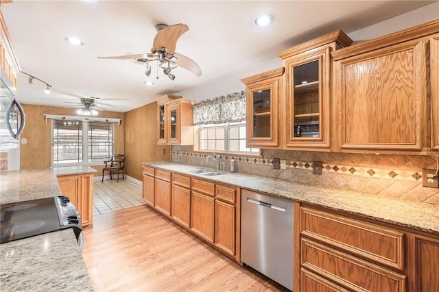 kitchen with a sink, electric stove, dishwasher, tasteful backsplash, and plenty of natural light