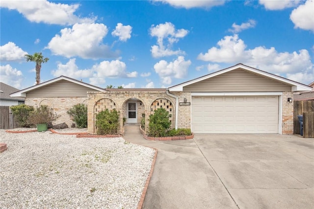 ranch-style home featuring driveway, an attached garage, and brick siding