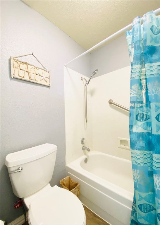 bathroom with toilet, hardwood / wood-style floors, a textured ceiling, and shower / bathtub combination with curtain