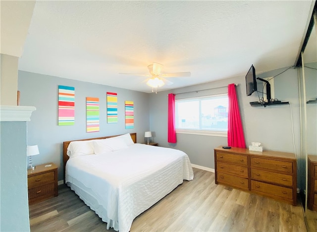 bedroom featuring light wood-type flooring and ceiling fan