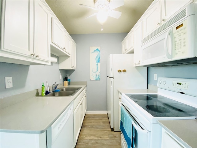 kitchen featuring white cabinetry, sink, white appliances, ceiling fan, and light hardwood / wood-style flooring