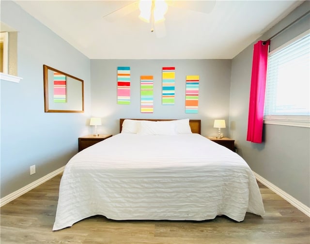 bedroom featuring hardwood / wood-style floors and ceiling fan