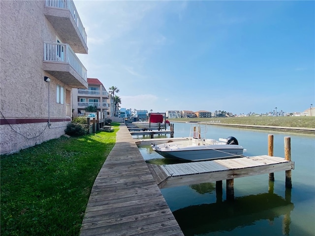 dock area featuring a balcony and a water view