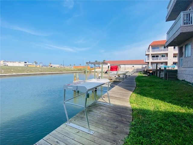 view of dock featuring a water view and a yard