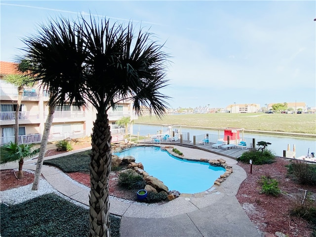 view of swimming pool featuring a water view