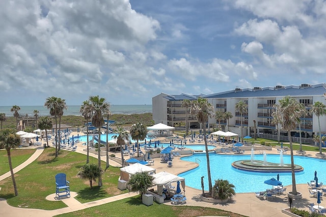 view of swimming pool featuring a water view, a patio area, a hot tub, a lawn, and a gazebo