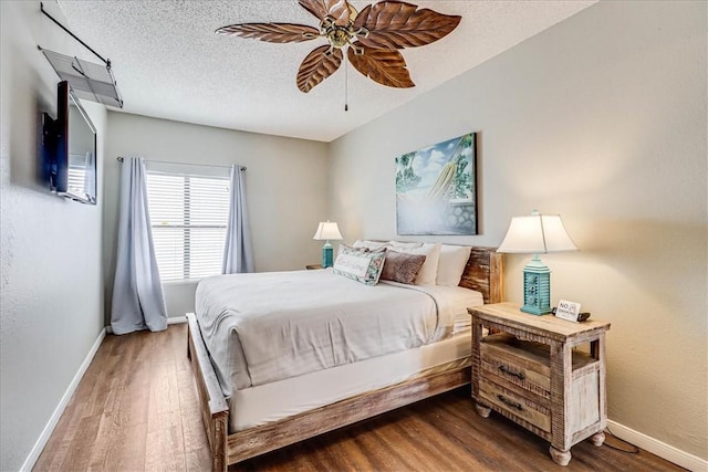 6317 State Highway 361 Unit 3307, Port Aransas, TX 78373 - bedroom featuring wood finished floors, baseboards, ceiling fan, and a textured ceiling