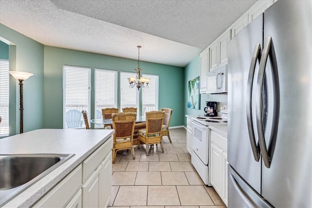 6317 State Highway 361 Unit 3307, Port Aransas, TX 78373 - kitchen with white appliances, light countertops, white cabinets, and a textured ceiling