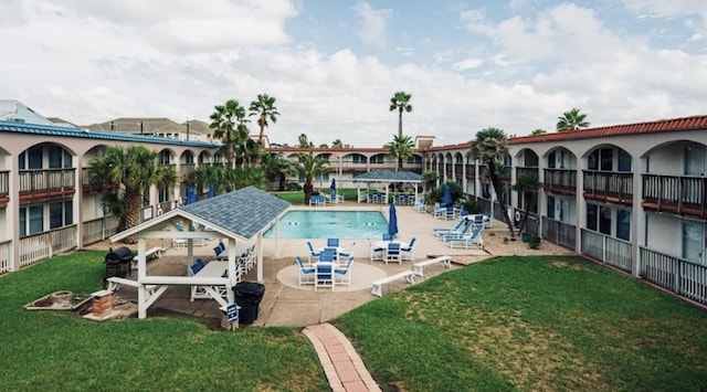 view of swimming pool featuring a patio area and a lawn