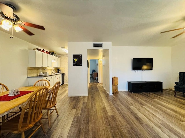 dining space with wood-type flooring