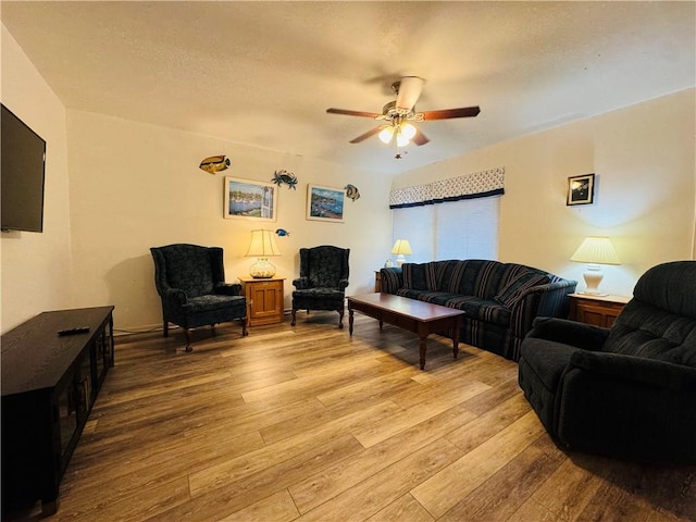 living room with ceiling fan and light hardwood / wood-style floors