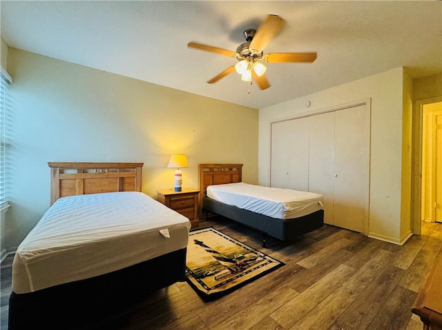 bedroom featuring a closet, ceiling fan, and dark wood-type flooring