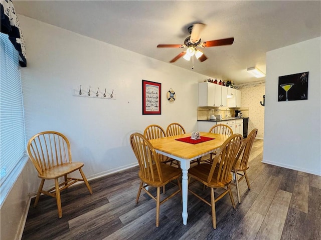 dining area with ceiling fan and dark wood-type flooring