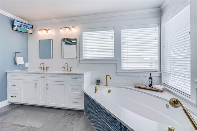 bathroom featuring vanity, ornamental molding, and tiled tub