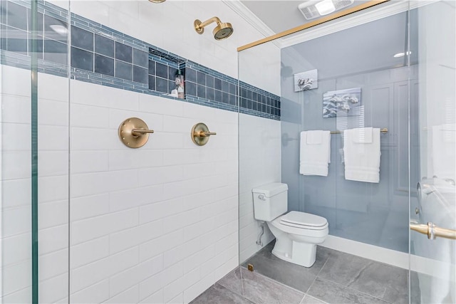 bathroom featuring tile patterned floors, toilet, a shower with door, and ornamental molding