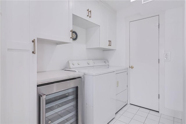 217 Port Saint Claire, Aransas Pass, TX 78336 - laundry area featuring washing machine and clothes dryer, wine cooler, cabinet space, and light tile patterned floors