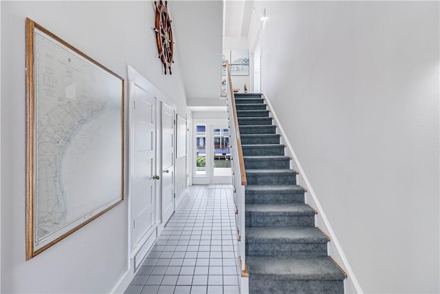 stairs featuring tile patterned flooring