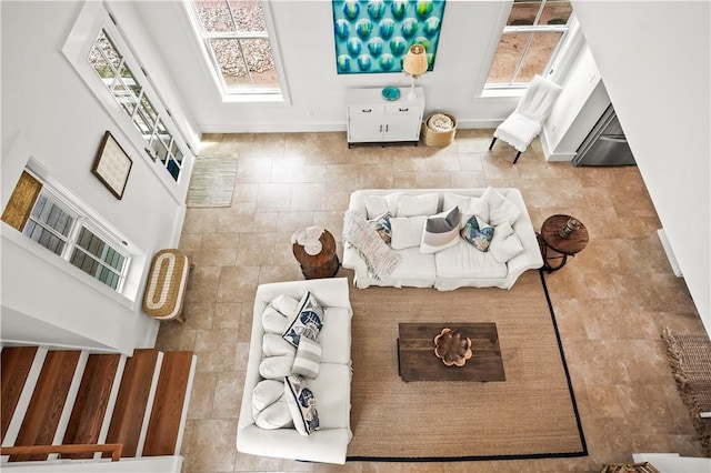 living area with a towering ceiling