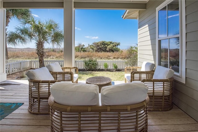 wooden terrace featuring an outdoor living space and fence