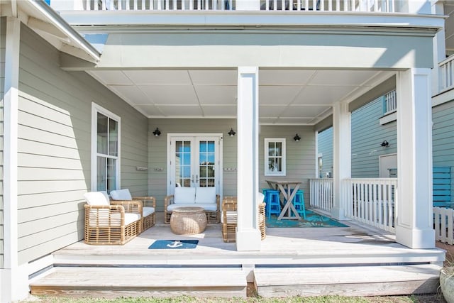 wooden deck featuring french doors and covered porch