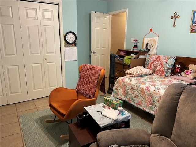 bedroom with light tile patterned floors and a closet