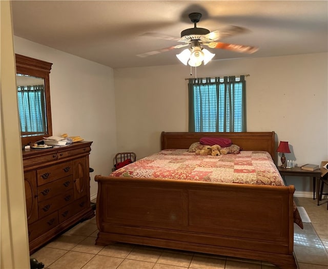 tiled bedroom with multiple windows and ceiling fan