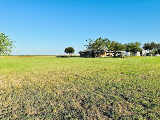 view of yard with a rural view