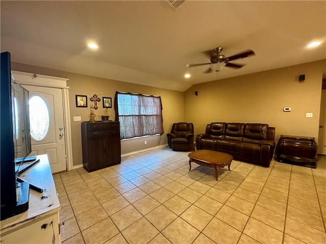 living room featuring plenty of natural light, ceiling fan, vaulted ceiling, and light tile patterned floors