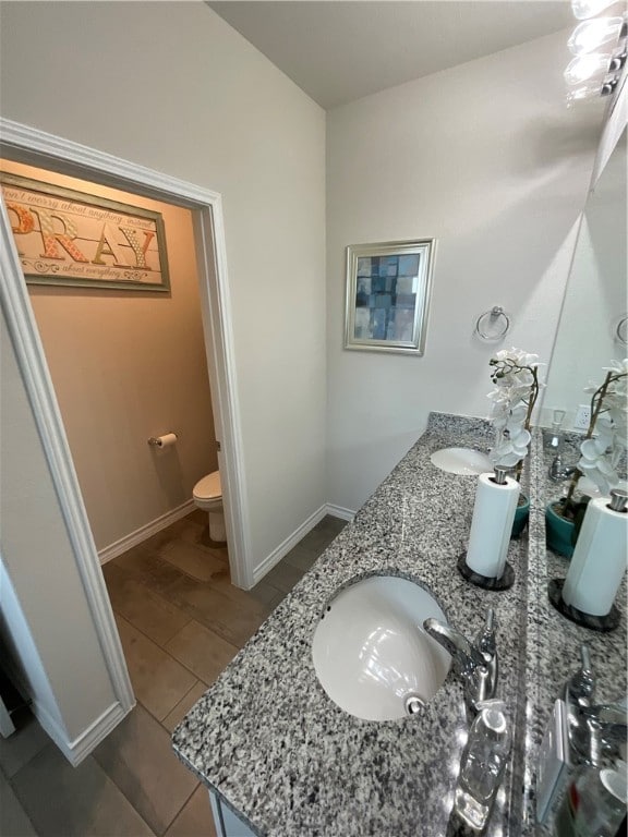 bathroom featuring hardwood / wood-style floors, vanity, and toilet