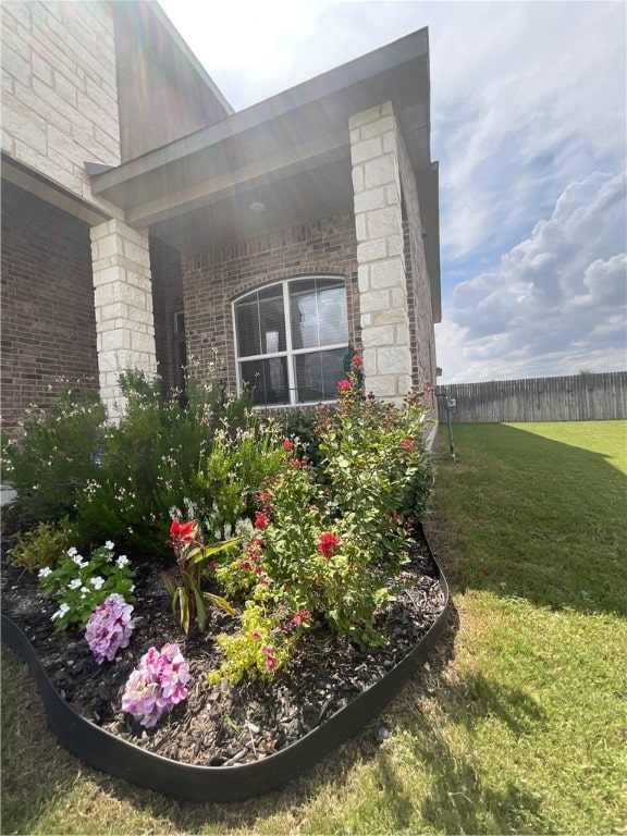 view of side of property with a yard