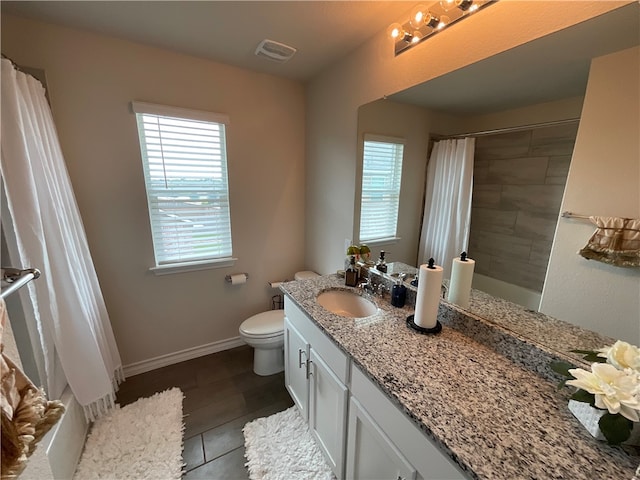 bathroom featuring toilet, vanity, tile patterned floors, and a shower with shower curtain