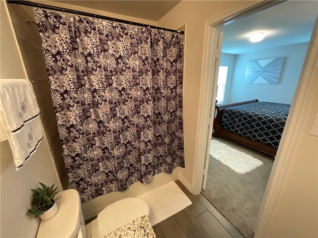 bathroom with walk in shower and wood-type flooring