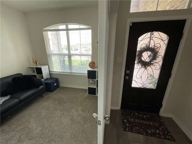 view of carpeted foyer entrance