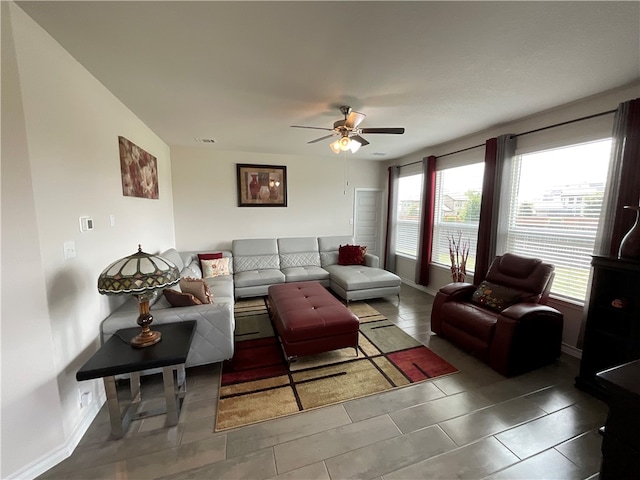 tiled living room with ceiling fan