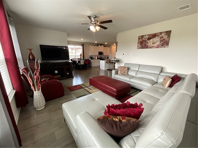 living room featuring hardwood / wood-style flooring and ceiling fan