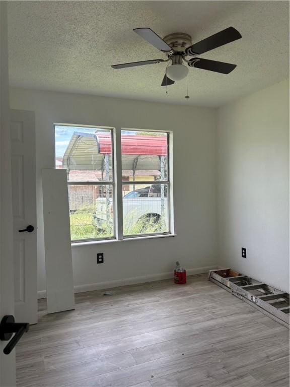4915 Cynthia St, Corpus Christi, TX 78410 - empty room with ceiling fan, light wood finished floors, and a textured ceiling
