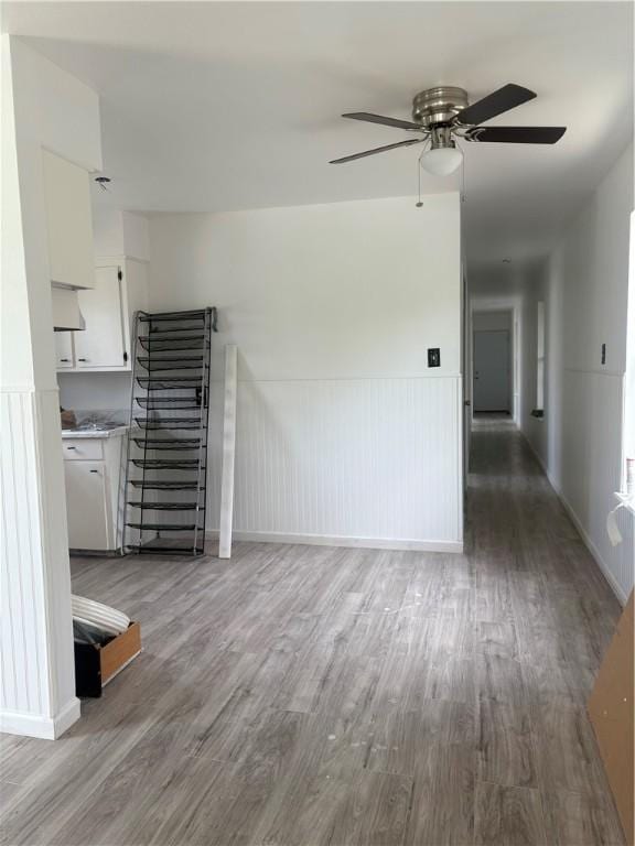 4915 Cynthia St, Corpus Christi, TX 78410 - unfurnished living room featuring wood finished floors, a ceiling fan, and a wainscoted wall