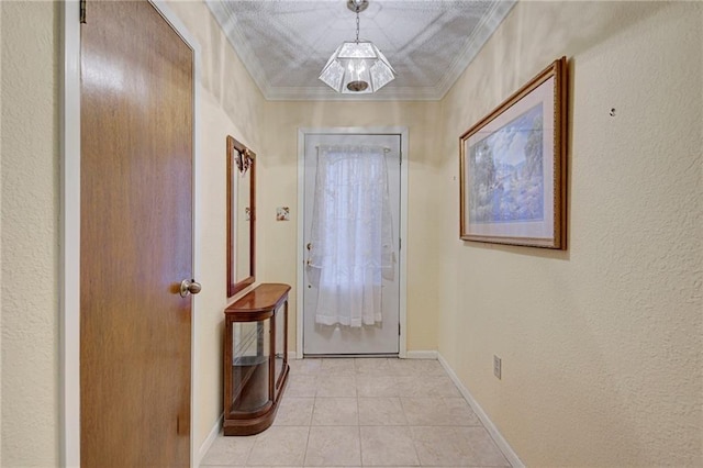 entryway with light tile patterned floors and crown molding