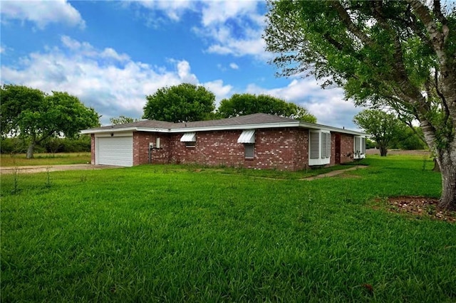 view of side of home with a garage and a lawn